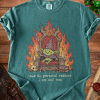 Green t-shirt with a goblin king on a throne, surrounded by flames, and text "due to personal reasons i am evil now".