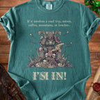 Green t-shirt with text and illustration of a warrior with skulls and a map.
