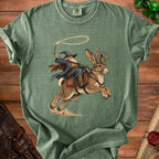 Wizard riding jackalope with lasso and wand on green t-shirt.