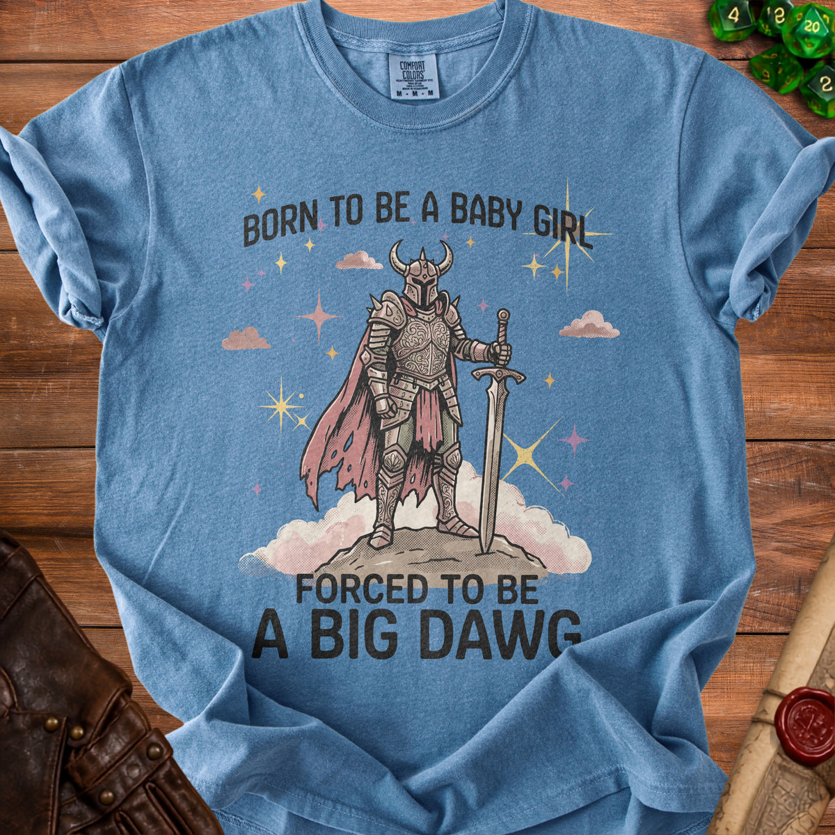 Blue t-shirt with knight and text "Born to be a baby girl, forced to be a big dawg."