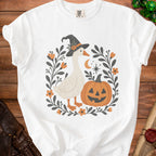 White t-shirt with a graphic of a goose wearing a witch hat and a jack-o'-lantern.