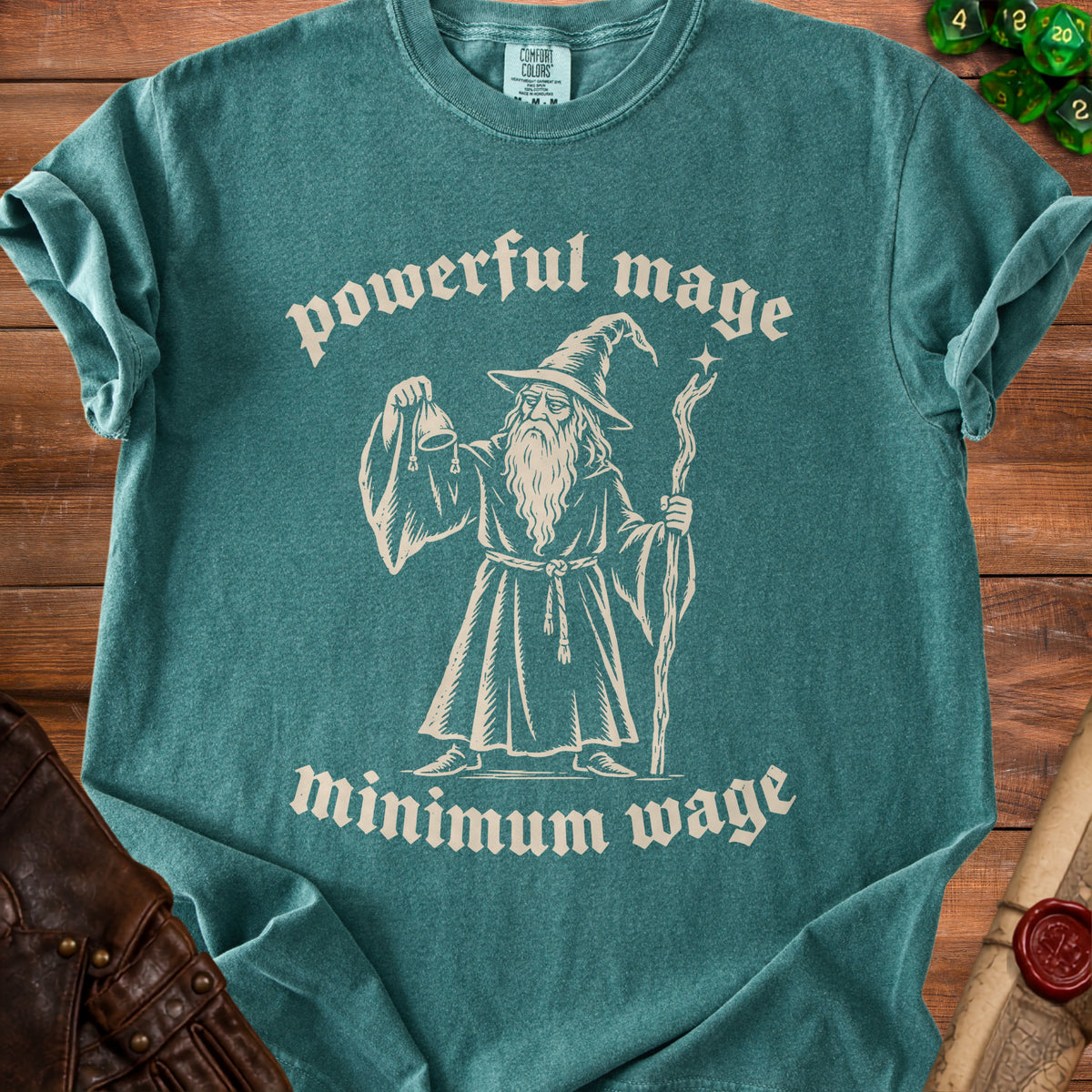Teal t-shirt with a graphic of a wizard and text "powerful mage minimum wage".