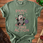 Green t-shirt with possum and dice graphic reads "Panic is a free action."