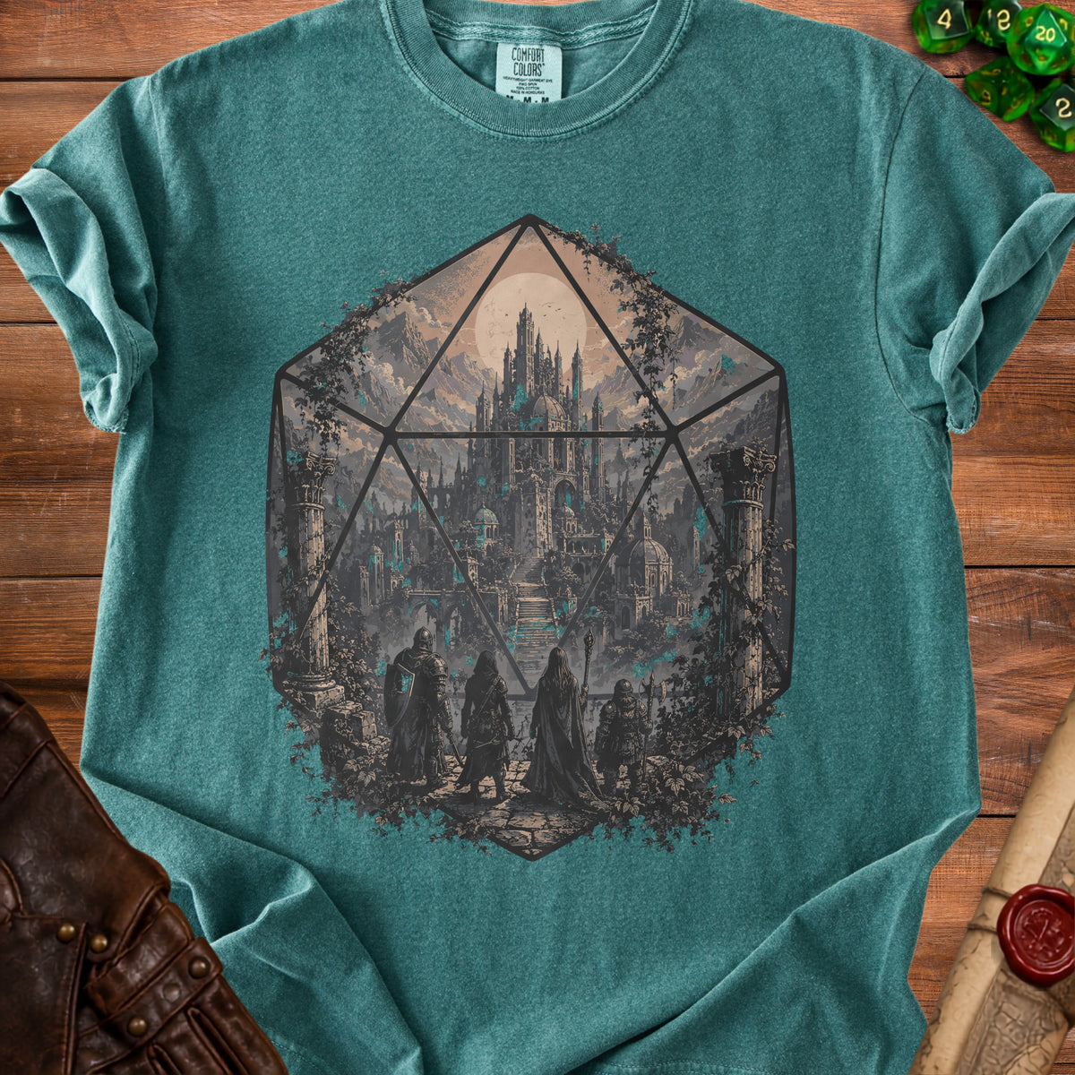 Teal t-shirt with graphic of adventurers before a fantasy castle within a D20 die.