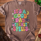 Brown t-shirt with "It's a good day to cast spells" in colorful bubble letters.