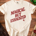 Cream t-shirt with maroon text that says "Magical But Exhausted".