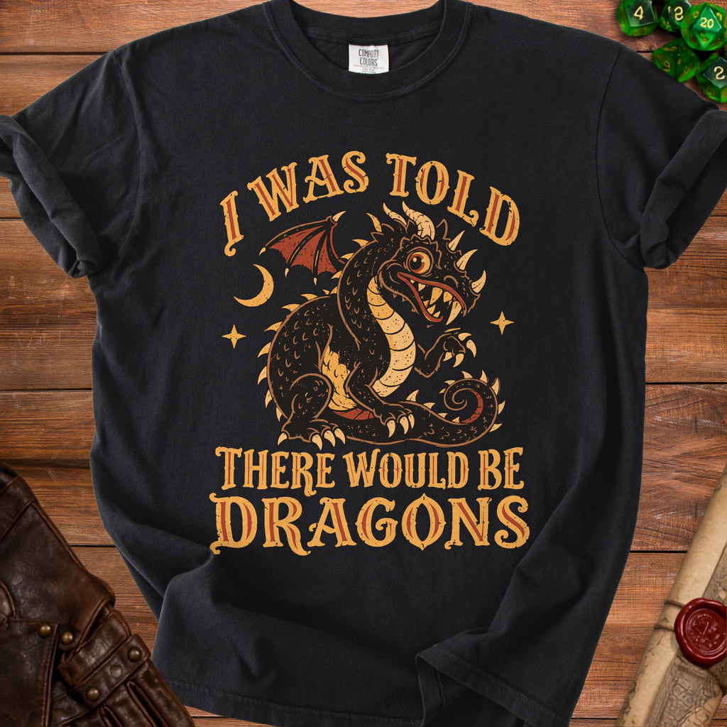 Black t-shirt with a distressed print of a dragon and the text "I WAS TOLD THERE WOULD BE DRAGONS".