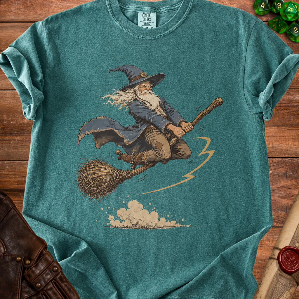 Teal t-shirt with graphic of wizard flying on a broomstick.