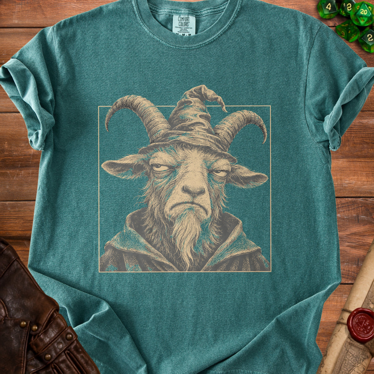 Teal t-shirt with illustration of a goat wearing a wizard hat and robe.