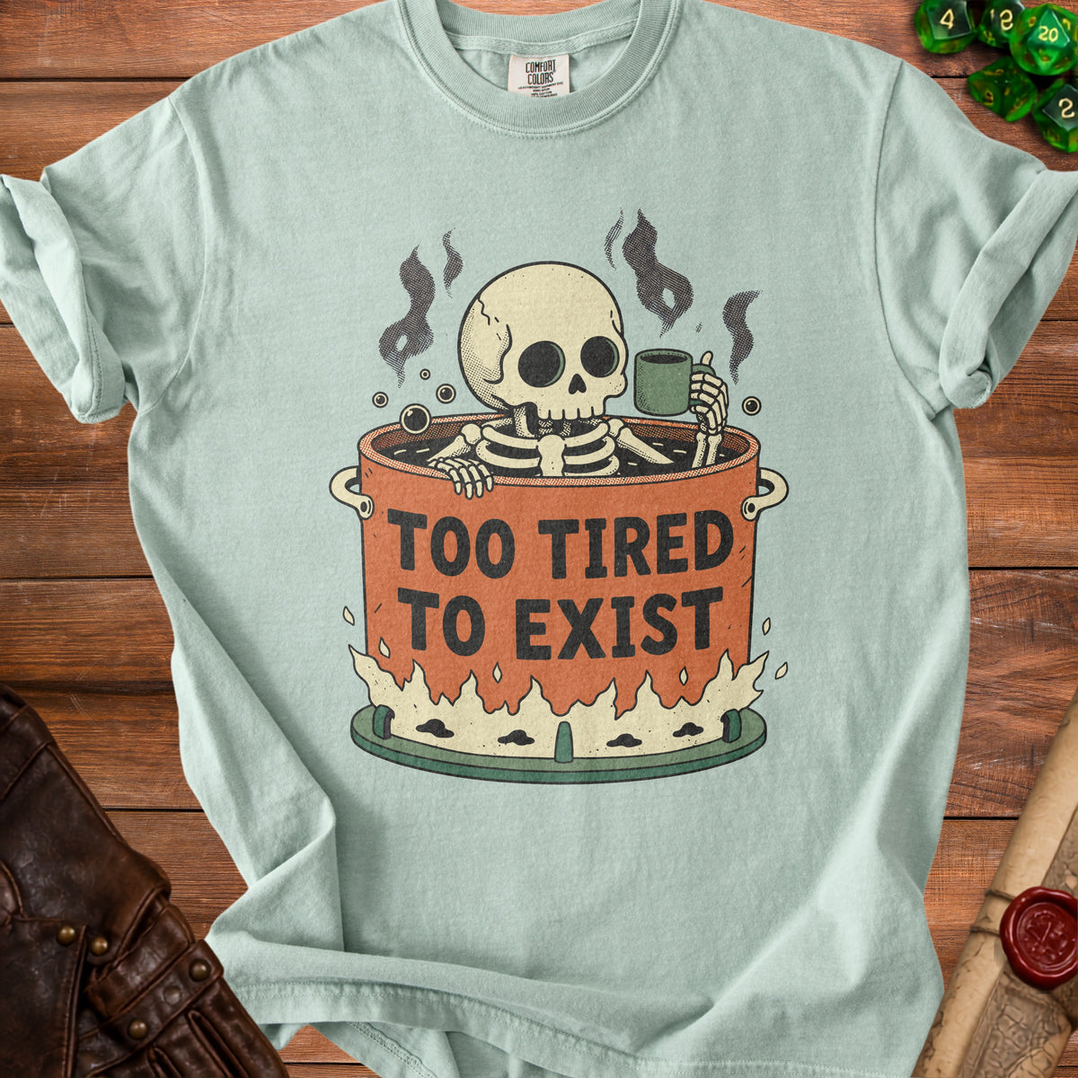 Skeleton sitting in a pot of coffee with the words "Too Tired To Exist".