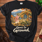 Goblin watering a hobbit hole in autumn with "Gone to Ground" text.