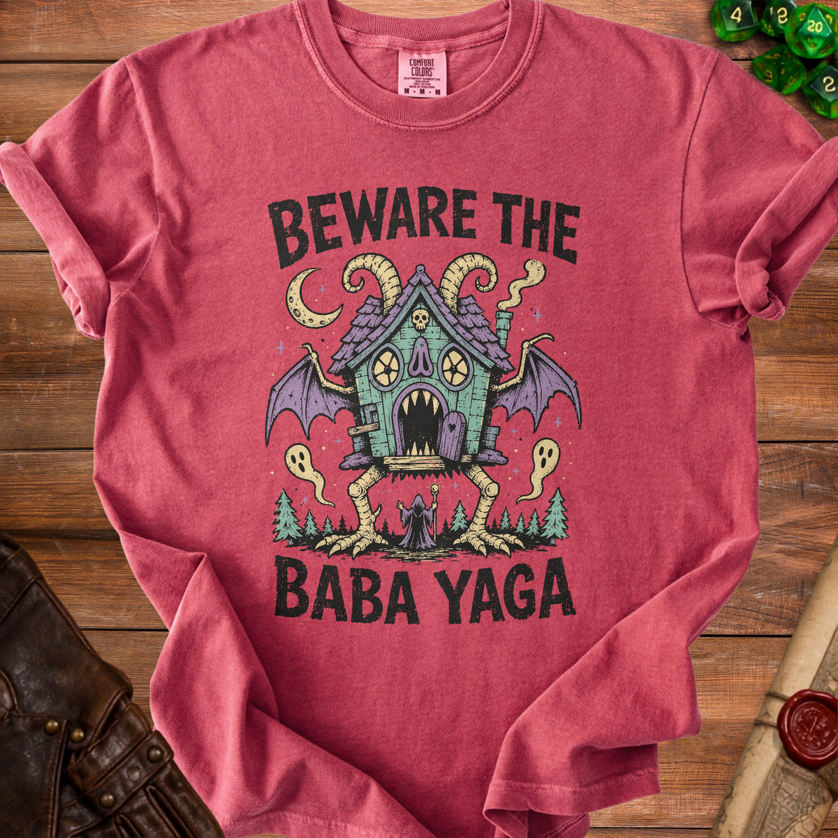 Red t-shirt with "Beware the Baba Yaga" text and a witch's house illustration.