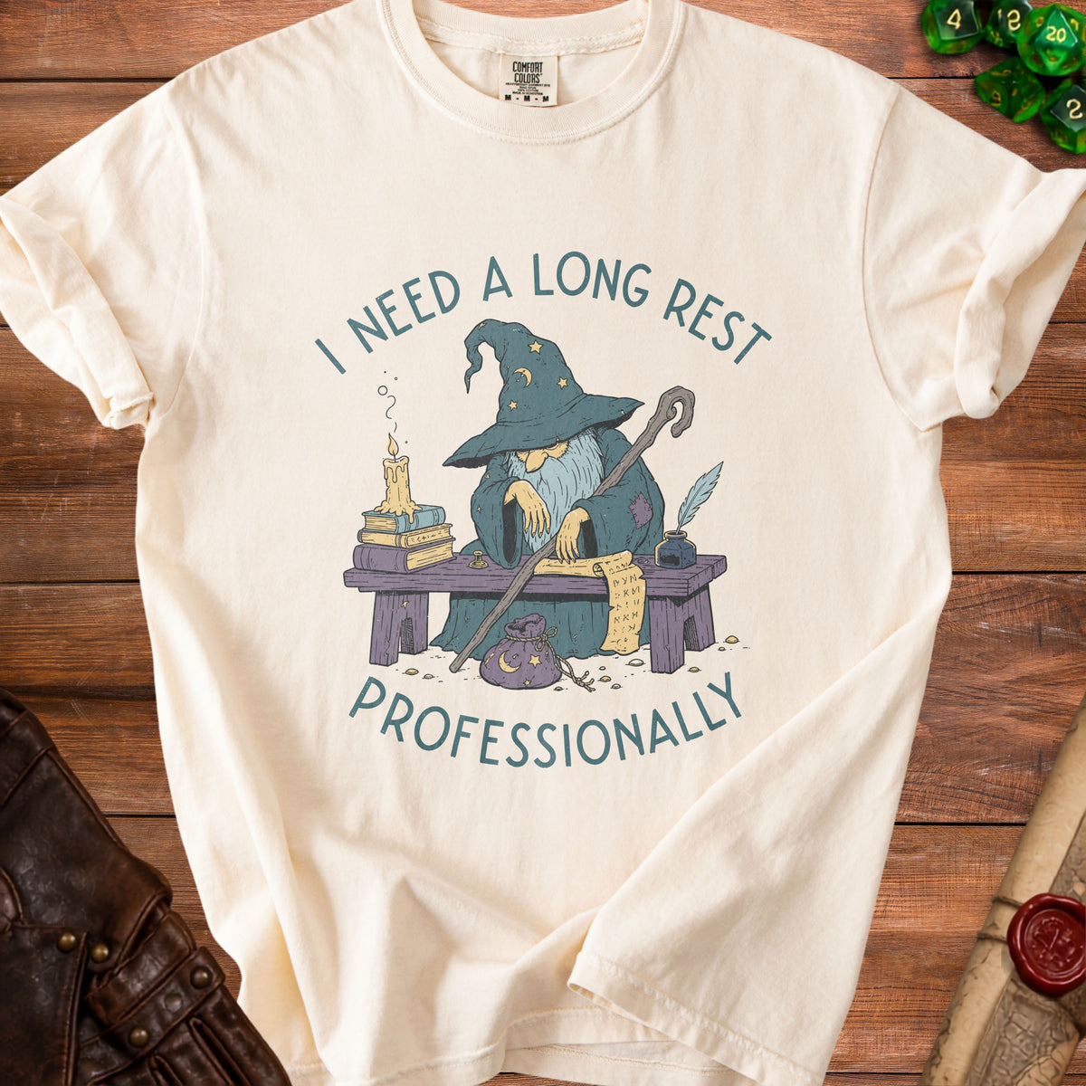 Cream t-shirt with a wizard design saying "I NEED A LONG REST PROFESSIONALLY".