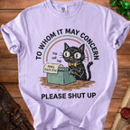 Light purple t-shirt with black cat on typewriter and text "TO WHOM IT MAY CONCERN PLEASE SHUT UP".