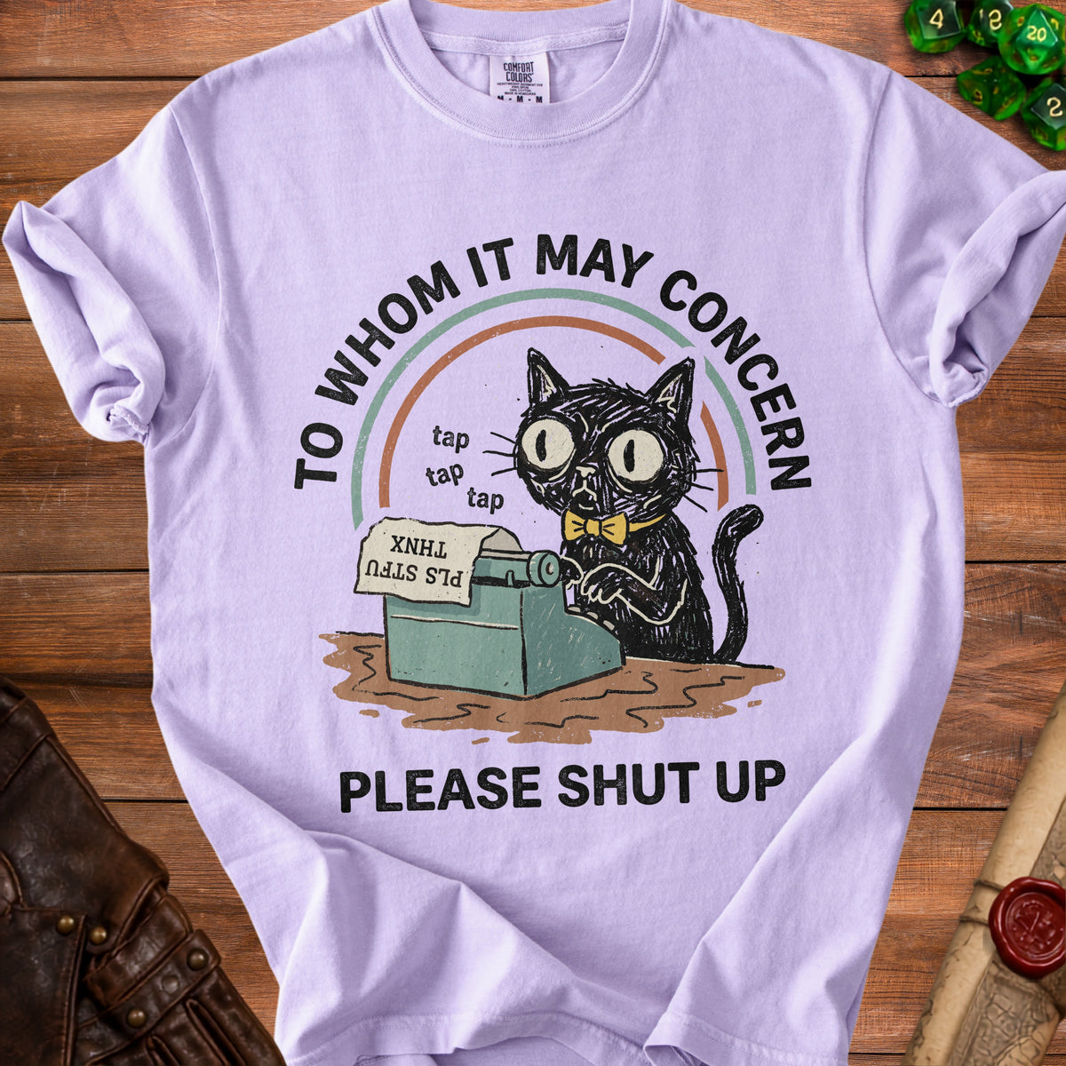 Light purple t-shirt with black cat on typewriter and text "TO WHOM IT MAY CONCERN PLEASE SHUT UP".