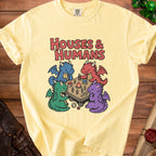 Yellow t-shirt with "Houses & Humans" text and cute dragons playing a tabletop game.