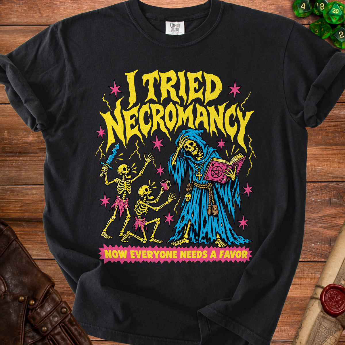 Black t-shirt with yellow text "I TRIED NECROMANCY" and image of skeletons and a grim reaper.