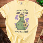 Yellow t-shirt with text "mentally attuned not matched" and a potion bottle graphic.