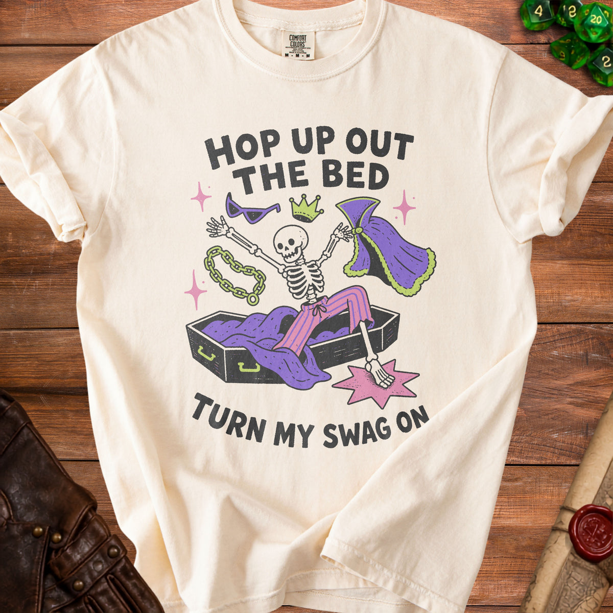Skeleton in coffin graphic with text "Hop up out the bed, turn my swag on."