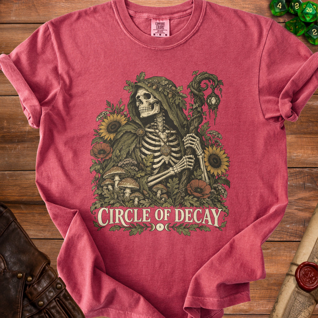 T-shirt with skeleton wearing a hooded cloak, surrounded by flowers and mushrooms, reading "CIRCLE OF DECAY".