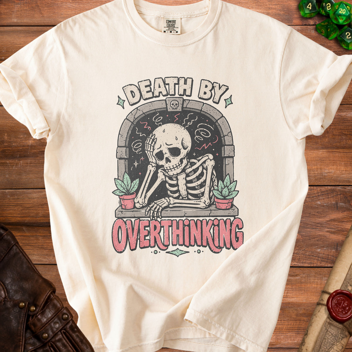 Cream t-shirt with skeleton graphic and text "DEATH BY OVERTHINKING".
