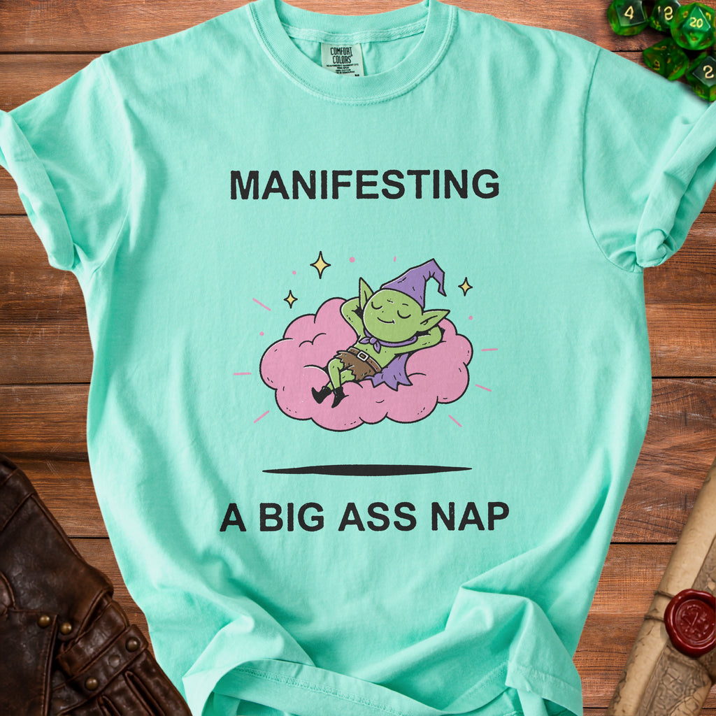 Mint t-shirt with "MANIFESTING A BIG ASS NAP" and a sleeping goblin on a cloud.