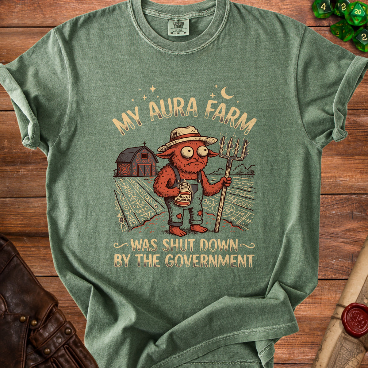 Green t-shirt with text "MY AURA FARM WAS SHUT DOWN BY THE GOVERNMENT".