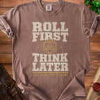 Brown t-shirt with "Roll First Think Later" and a D20 dice.