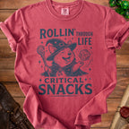 Red t-shirt with a Corgi wizard graphic reading "Rollin' Through Life, Critical Snacks".