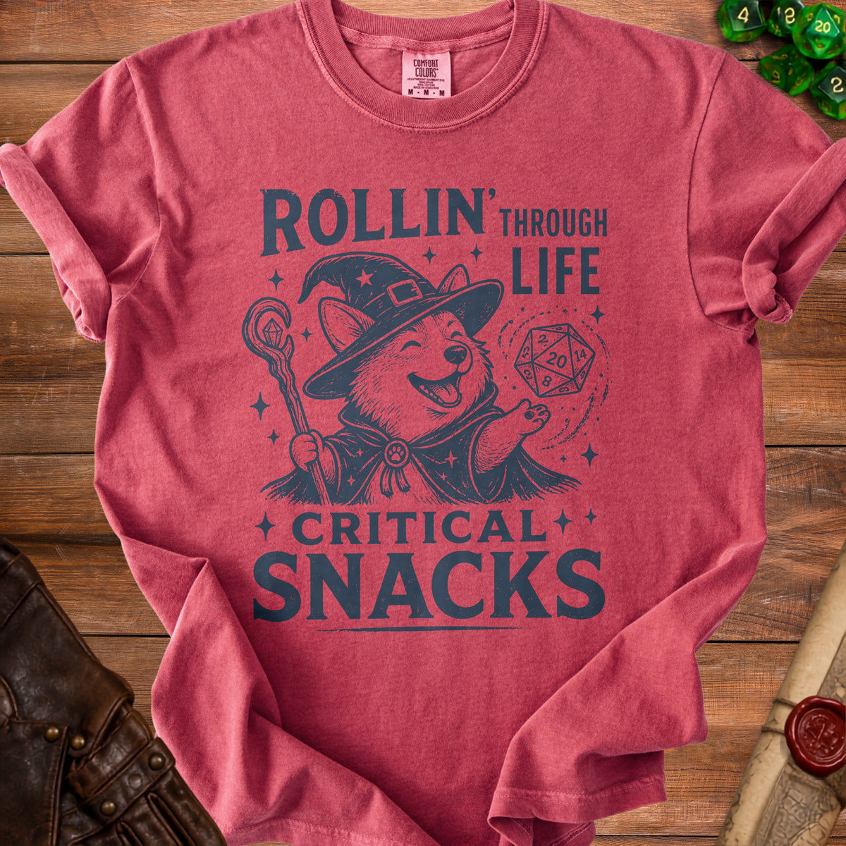 Red t-shirt with a Corgi wizard graphic reading "Rollin' Through Life, Critical Snacks".