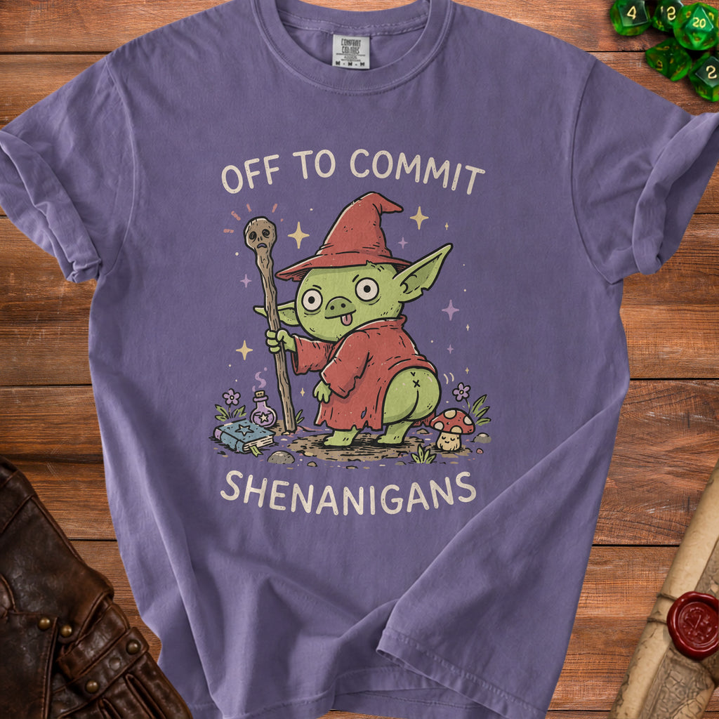 Purple t-shirt with illustration of a goblin wizard holding a staff and text "OFF TO COMMIT SHENANIGANS".