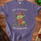 Purple t-shirt with illustration of a goblin wizard holding a staff and text "OFF TO COMMIT SHENANIGANS".