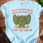 Light blue t-shirt with a creature saying "Wish my parents would've added some nepo to the tism they gave me".
