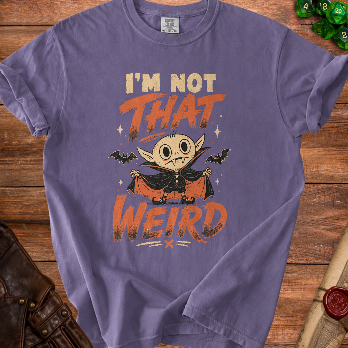 Purple t-shirt with cartoon vampire graphic and text "I'm Not That Weird."