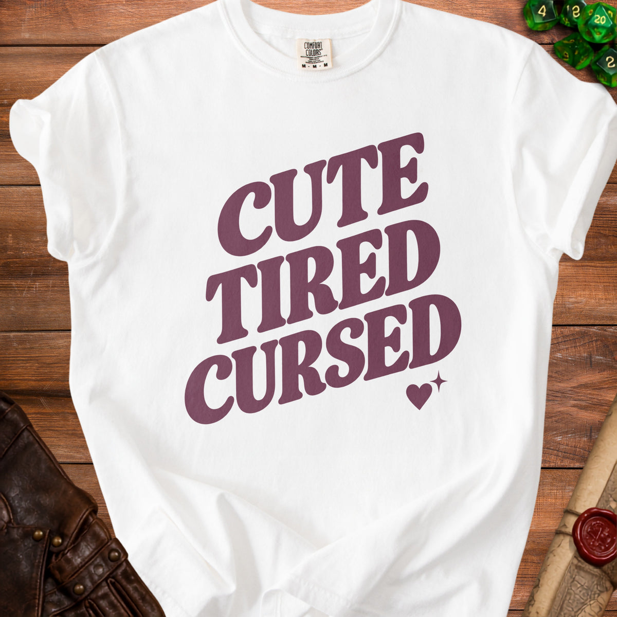 White t-shirt with burgundy text "CUTE TIRED CURSED" and heart graphic.