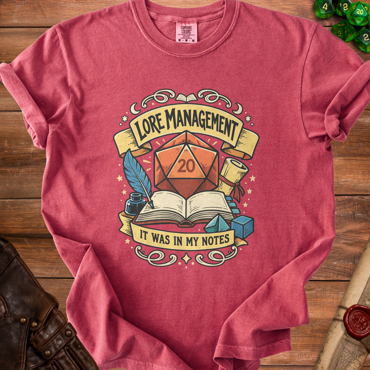 T-shirt with D20 dice, open book, quill and ink, saying "Lore Management, It Was In My Notes".