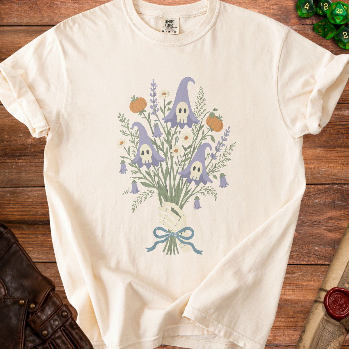 T-shirt with a skeleton hand holding a bouquet of ghost-shaped flowers and pumpkins.