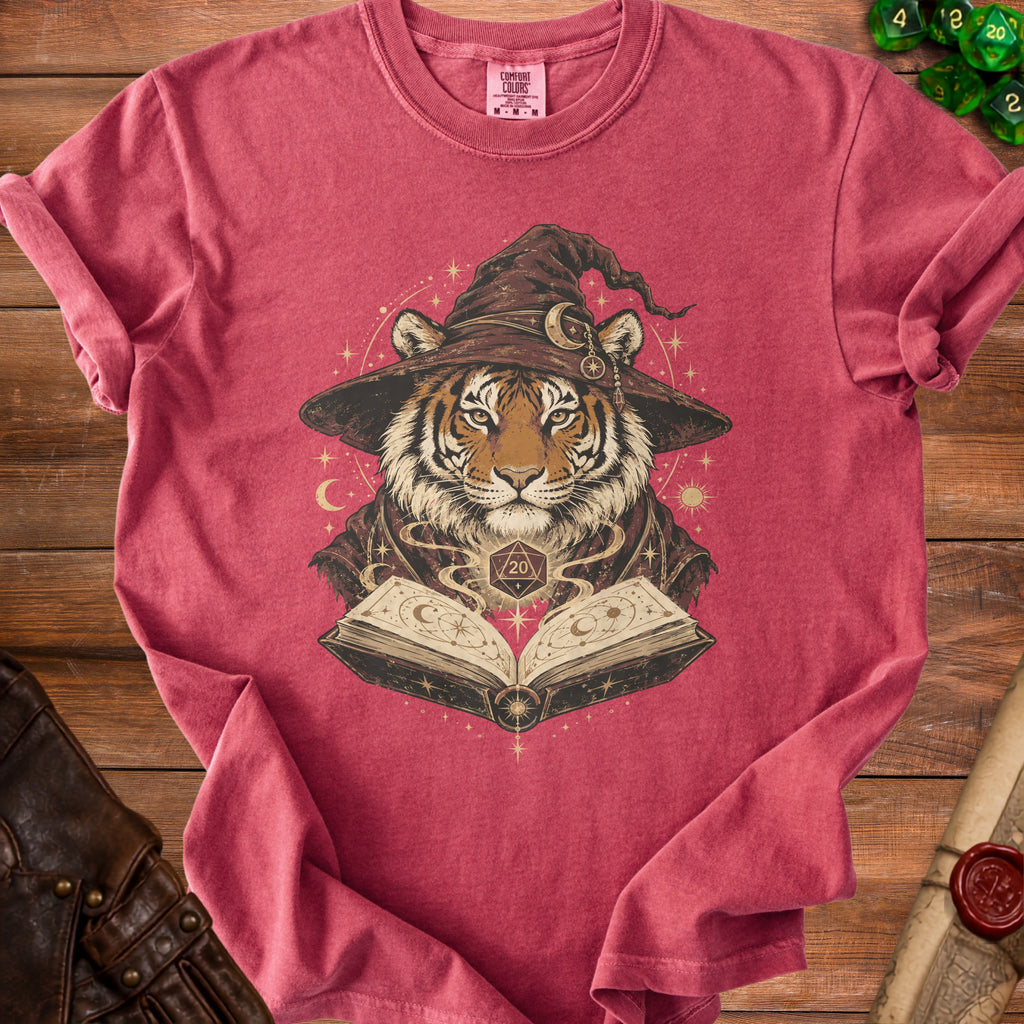 Tiger wearing a wizard hat reads an open spell book with a D20 die.