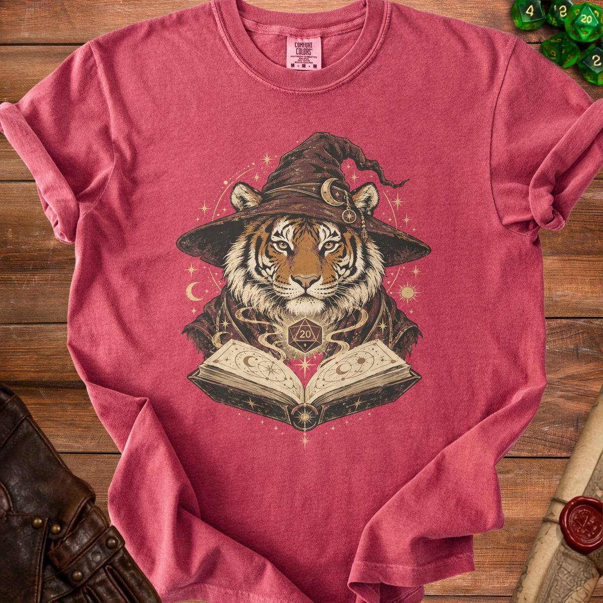 Tiger wearing a wizard hat reads an open spell book with a D20 die.