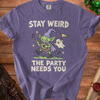 Purple t-shirt with a goblin playing music and a ghost, reads "Stay Weird The Party Needs You".