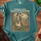 T-shirt with "Terrible Times Excellent Mushrooms" text and witch with mushrooms and deer.