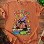 Black cat in wizard hat reads "But Books Help" on stack of books, with frog.