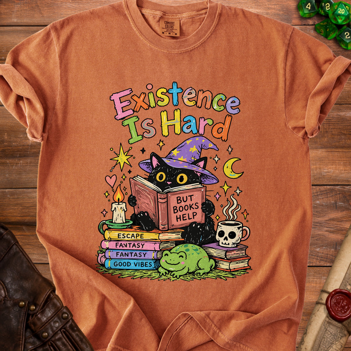 Black cat in wizard hat reads "But Books Help" on stack of books, with frog.