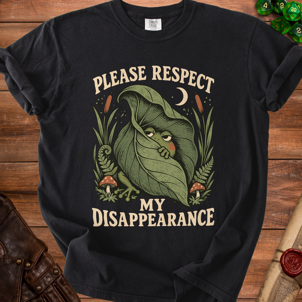 Black t-shirt with a frog peeking from behind a leaf, text "Please Respect My Disappearance".
