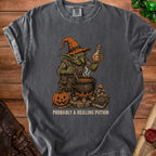 Dark grey t-shirt with a goblin brewing a potion, text reads "Probably A Healing Potion".