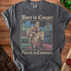 T-shirt graphic of a knight on a horse in traffic, reading "Born to Conquer Forced to Commute."
