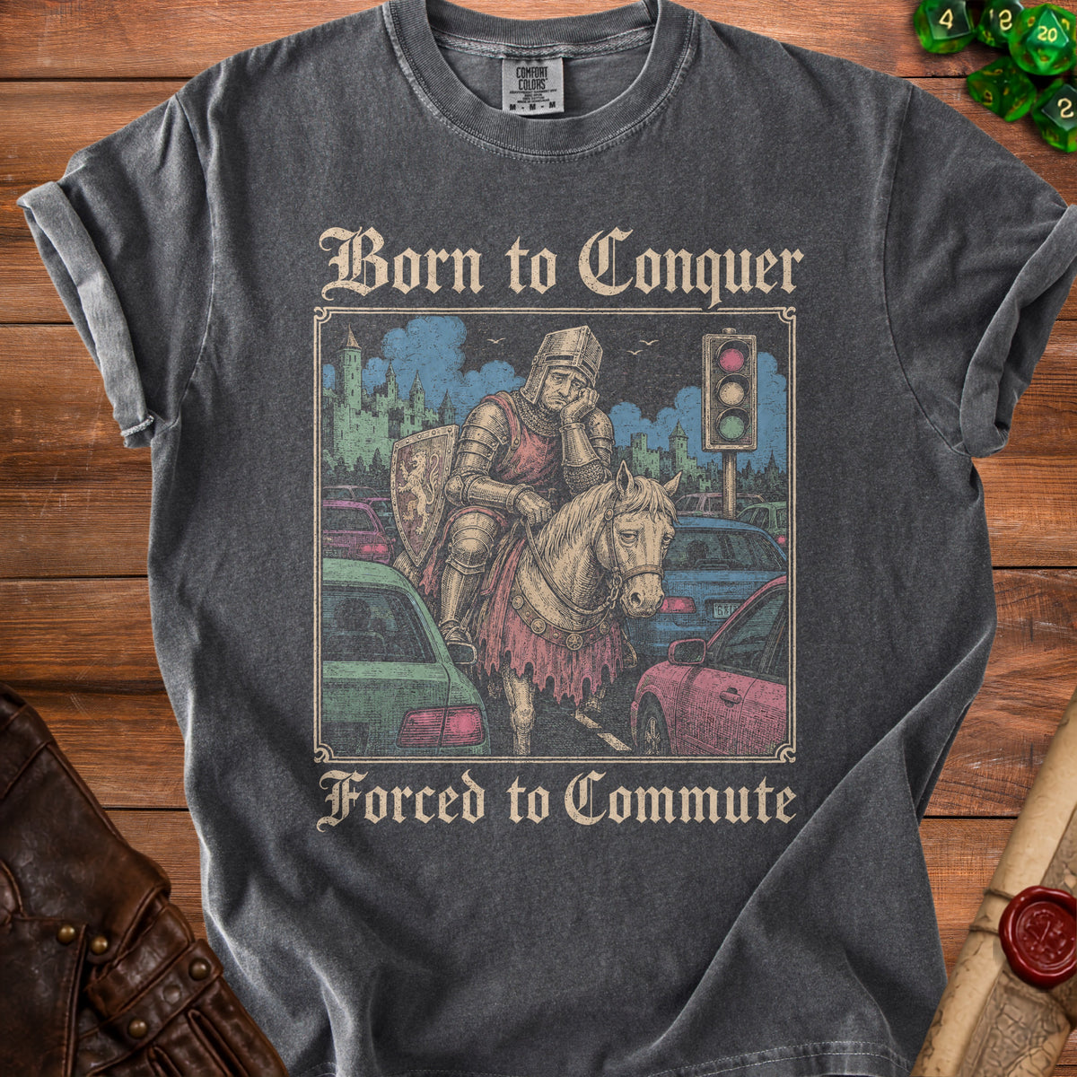 T-shirt graphic of a knight on a horse in traffic, reading "Born to Conquer Forced to Commute."
