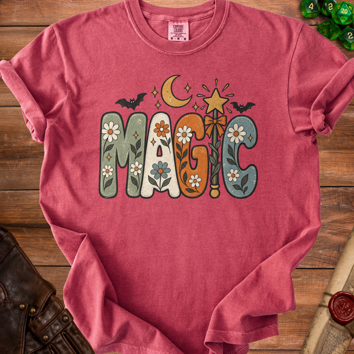 Red t-shirt with "MAGIC" text in groovy font with stars, moon, bat and wand.