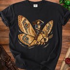 Cowgirl riding a large moth with intricate wing patterns.