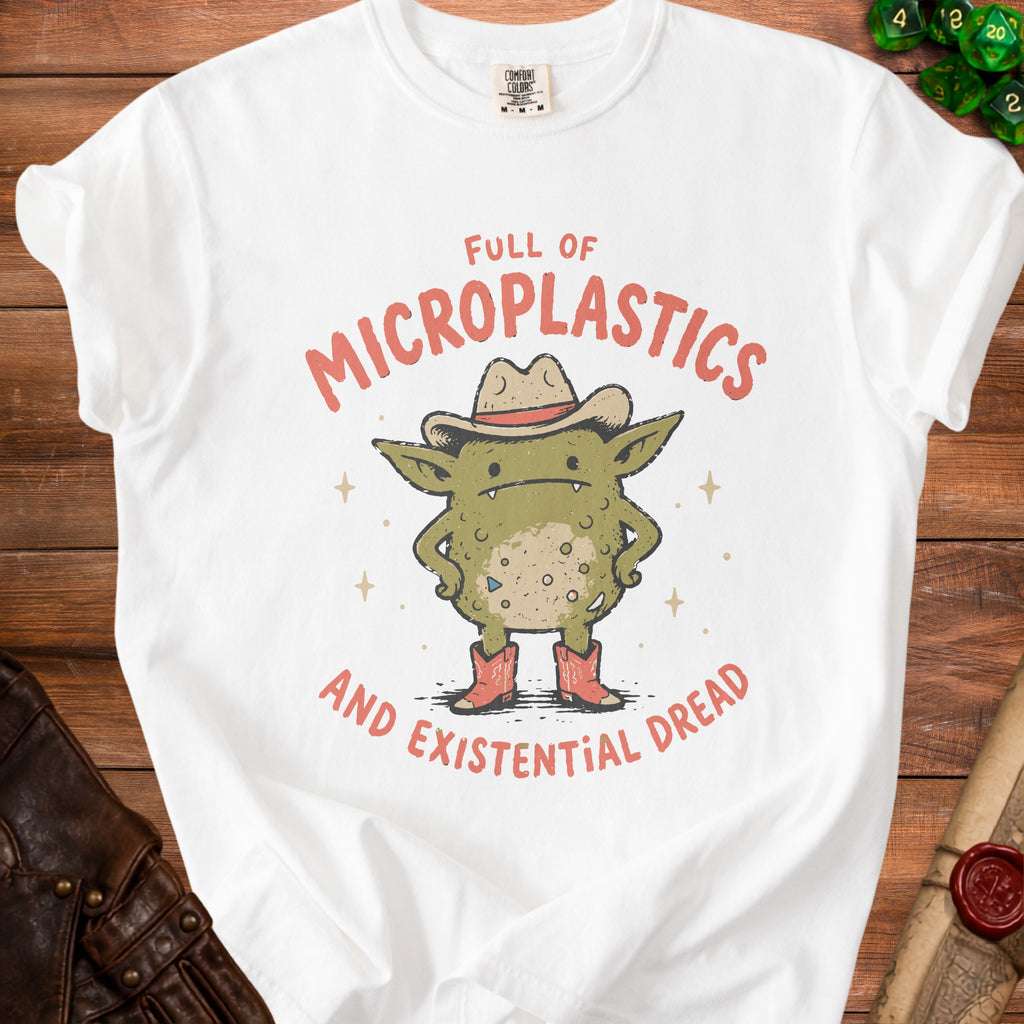 White t-shirt with a cartoon creature wearing a cowboy hat and boots, text reads "Full of Microplastics and Existential Dread."